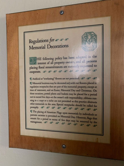 [Sign mounted on board screwed
into wall announcing "Regulations for Memorial Decorations," transcribed
below.]
