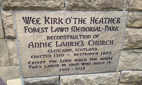 [Close-up of cut stone sign set
into church wall declaring the "Wee Kirk" to be a "reconstruction" of the 14th
century church at which "Annie Laurie" worshipped.]