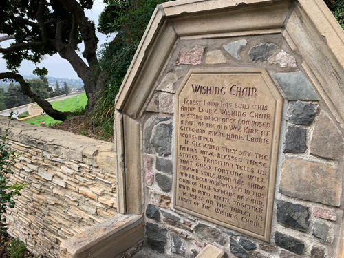 [Cut stone sign set into "the
Wishing Chair," transcribed below.]