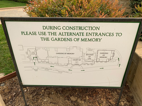 [Sign directing traffic with a
diagram and the words "During construction please use the alternate entrances to
the Gardens of Memory."]