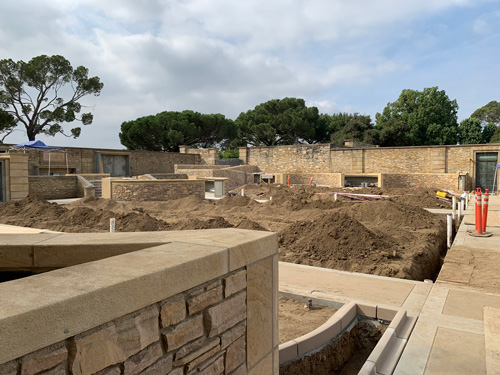 [View of a walled courtyard with
mounds of dirt.]