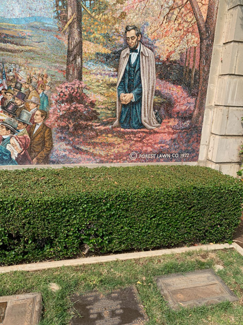 [Detail of a mosaic depicting
Abraham Lincoln on his knees in a forest, with a Forest Lawn copyright notice
part of the design of the image.]