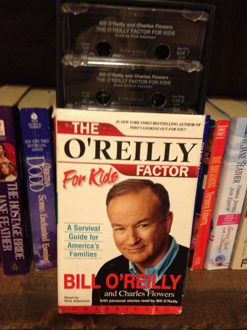[Misc. photograph 52. For sale at a
thrift shop, "The O`Reilly Factor For Kids" as an unabridged book on tape.]