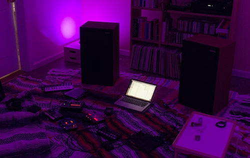 [Photograph of audio equipment on blankets
prior to the recording of "MONO-002."]