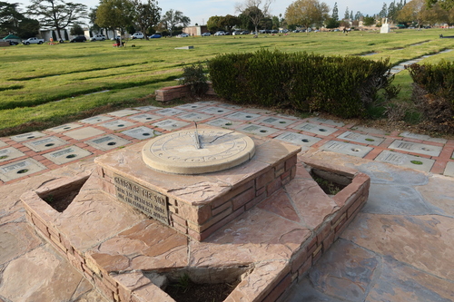 [Sun dial in a brick courtyard
with a copper sign announcing "Garden of the Sun."]