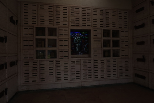 [Marble sarcophagus under a
mosaic representing an oil painting of two children clinging to a woman. Metal
lettering identifies this as the grave of Ronnie James Dio, including a
representation of his signature.]