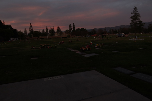 [Silhouette of a mausoleum
against a pink sunset sky.]